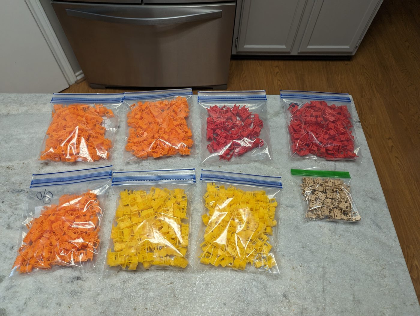 Bagged forklifts sorted into orange, red, yellow, and tan batches