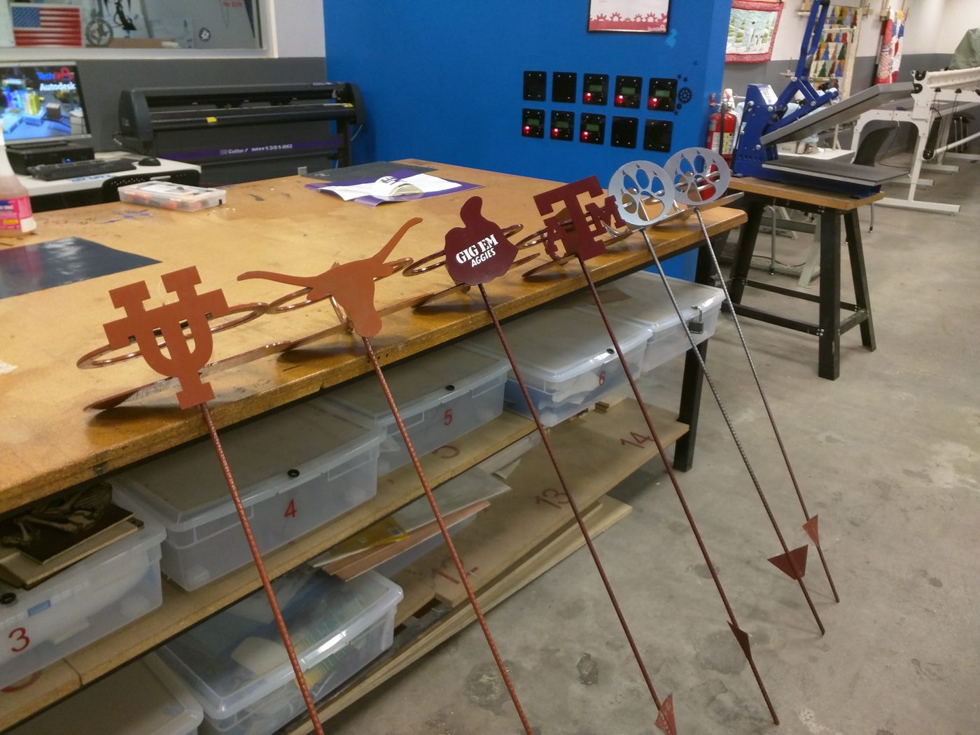 Rebar garden stakes topped with team logos