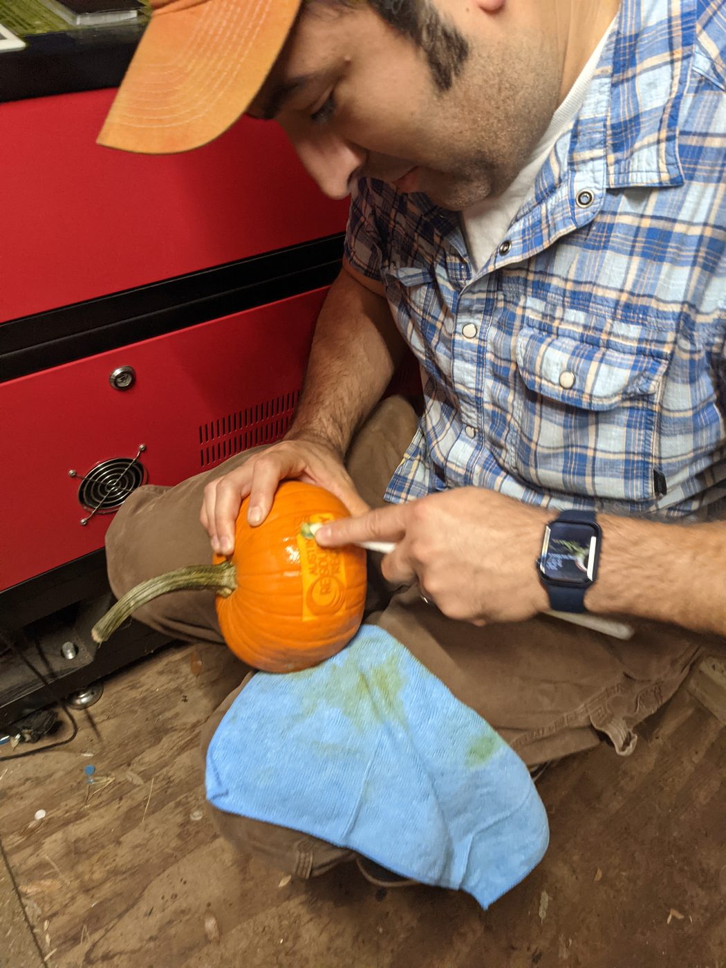 Cleaning up a carved pumpkin with a shop logo
